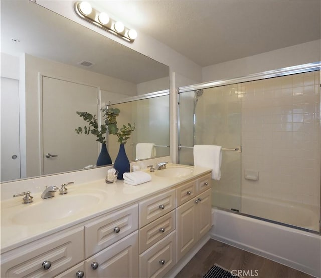 1281 Cabrillo Ave Unit 303, Torrance, CA 90501 - bathroom featuring double vanity, shower / bath combination with glass door, and wood finished floors