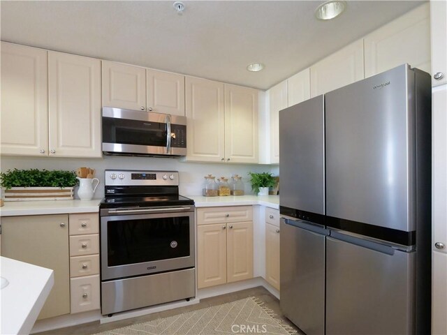 1281 Cabrillo Ave Unit 303, Torrance, CA 90501 - kitchen featuring stainless steel appliances, light countertops, white cabinets, and recessed lighting