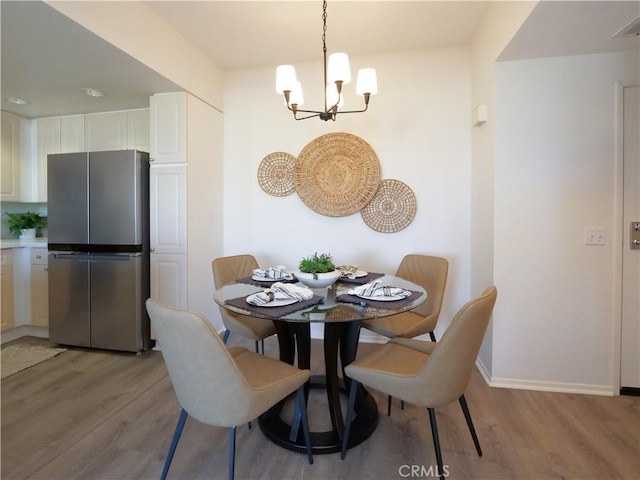 1281 Cabrillo Ave Unit 303, Torrance, CA 90501 - dining area featuring a chandelier and light wood finished floors