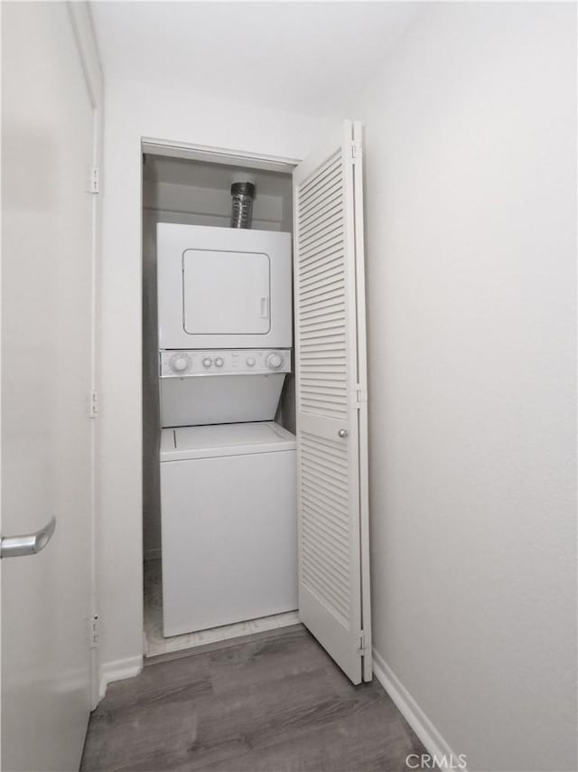 1281 Cabrillo Ave Unit 303, Torrance, CA 90501 - washroom featuring stacked washer / drying machine and wood finished floors