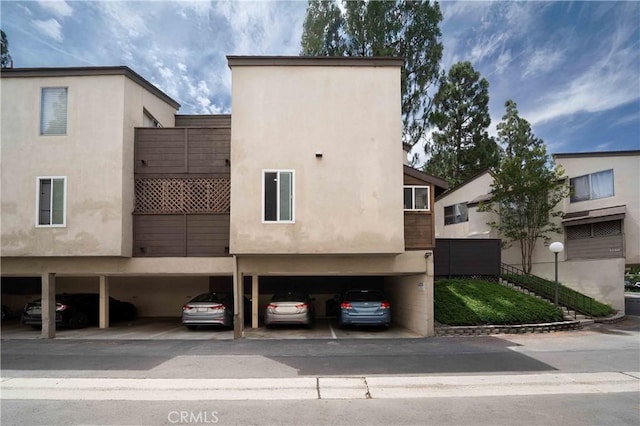 1320 Cabrillo Park Dr Unit D, Santa Ana, CA 92701 - view of building exterior featuring covered parking