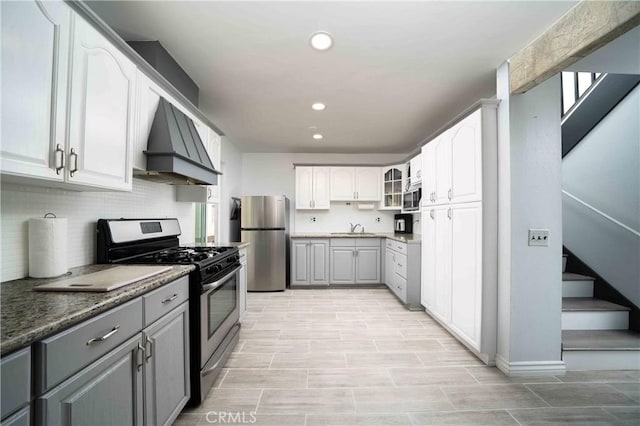 1320 Cabrillo Park Dr Unit D, Santa Ana, CA 92701 - kitchen with stainless steel appliances, custom exhaust hood, gray cabinets, glass insert cabinets, and recessed lighting