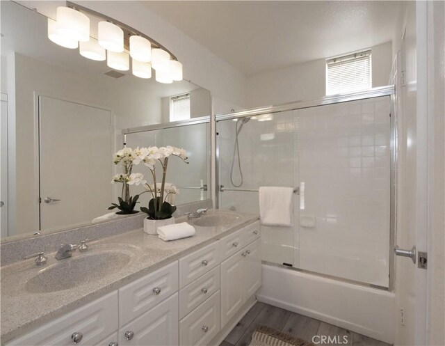 1281 Cabrillo Ave Unit 306, Torrance, CA 90501 - full bath with double vanity, combined bath / shower with glass door, and wood finished floors