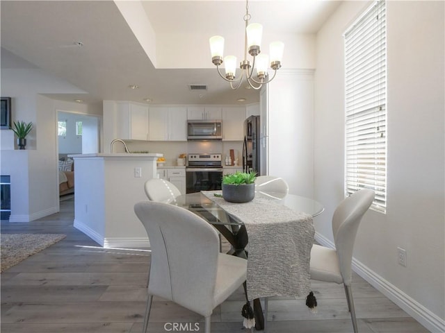 1281 Cabrillo Ave Unit 306, Torrance, CA 90501 - dining area with a chandelier and light wood-type flooring