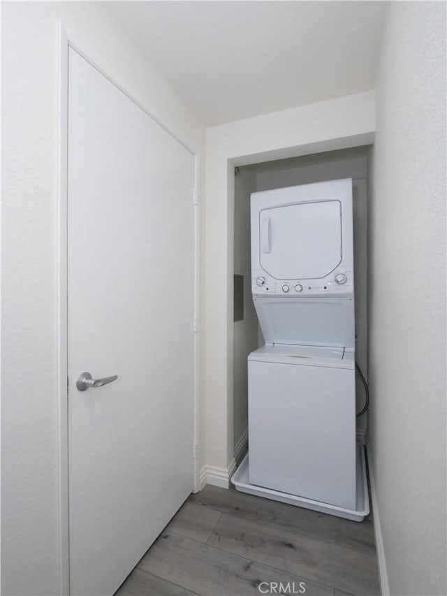 1281 Cabrillo Ave Unit 306, Torrance, CA 90501 - washroom with stacked washer / dryer and wood finished floors