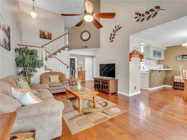 2756 Lemon Dr, Simi Valley, CA 93063 - living room with wood-type flooring, stairs, a ceiling fan, and a high ceiling