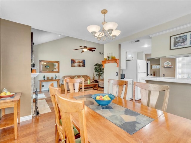 2756 Lemon Dr, Simi Valley, CA 93063 - dining area with a chandelier, light wood-style flooring, a ceiling fan, and vaulted ceiling