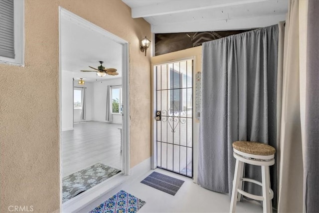 74697 Baseline Rd Unit 29, Palms, CA 92277 - entryway with a textured wall, beamed ceiling, and ceiling fan