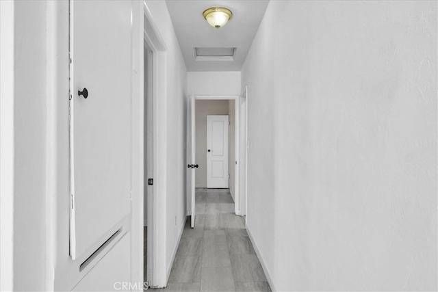 74697 Baseline Rd Unit 29, Palms, CA 92277 - corridor with baseboards and attic access