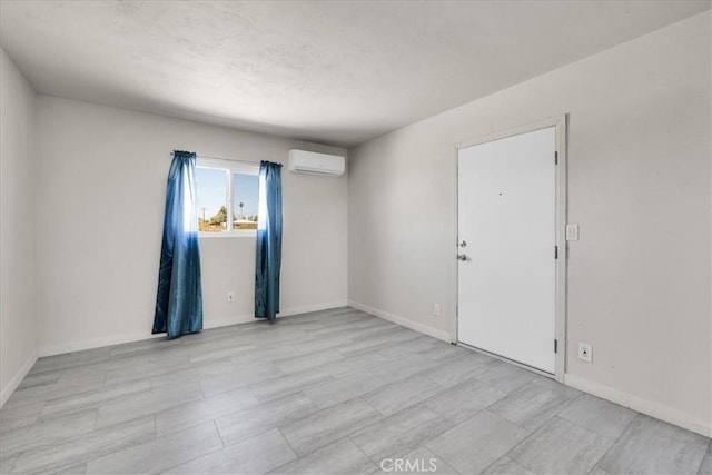 74697 Baseline Rd Unit 29, Palms, CA 92277 - spare room featuring a wall unit AC and baseboards