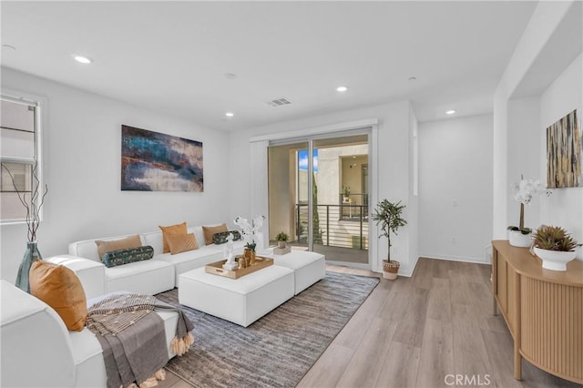 208 Harringay, Irvine, CA 92618 - living area featuring light wood-style flooring and recessed lighting