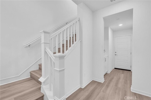 208 Harringay, Irvine, CA 92618 - staircase with wood finished floors and baseboards