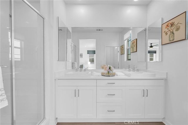 208 Harringay, Irvine, CA 92618 - bathroom with double vanity, ceiling fan, a stall shower, and healthy amount of natural light