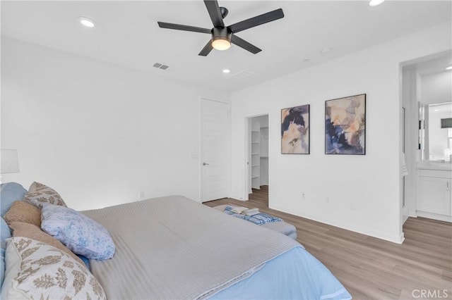 208 Harringay, Irvine, CA 92618 - bedroom featuring wood finished floors, recessed lighting, a walk in closet, ceiling fan, and connected bathroom