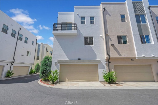 208 Harringay, Irvine, CA 92618 - view of front of property featuring stucco siding and an attached garage