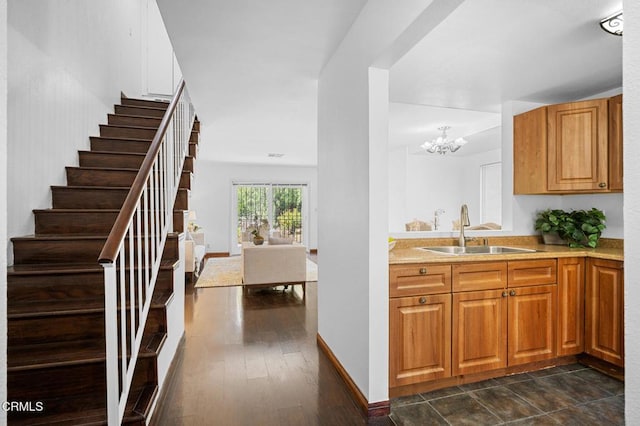 5036 Echo St Unit 37, Los Angeles, CA 90042 - kitchen featuring light countertops, a chandelier, and brown cabinetry