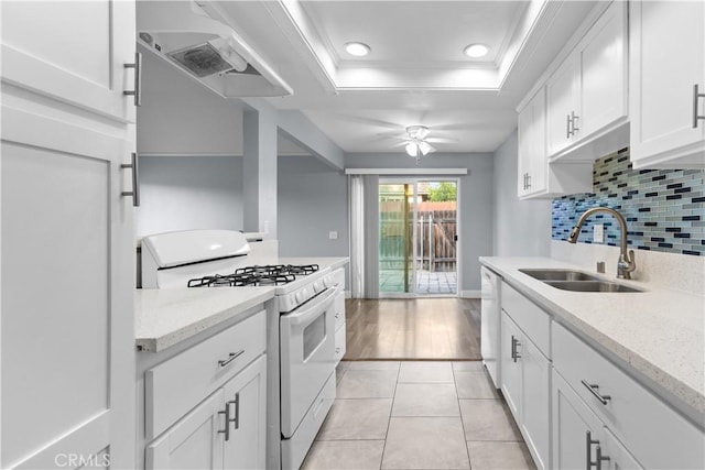 1477 Clemson Way, Riverside, CA 92507 - kitchen featuring white appliances, a raised ceiling, white cabinets, wall chimney exhaust hood, and tasteful backsplash