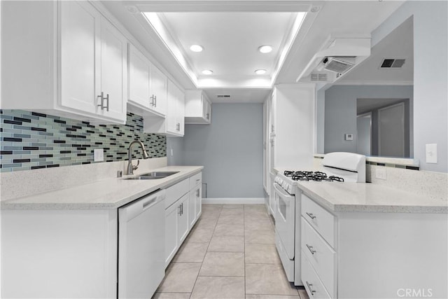 1477 Clemson Way, Riverside, CA 92507 - kitchen with white appliances, a tray ceiling, tasteful backsplash, white cabinets, and recessed lighting