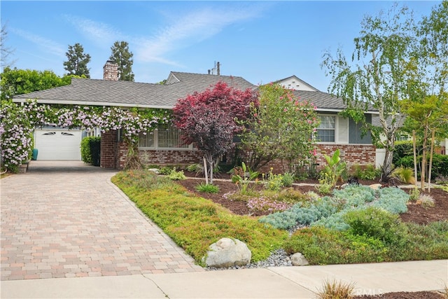 406 University Ave, Burbank, CA 91504 - view of front facade featuring brick siding, decorative driveway, and a chimney