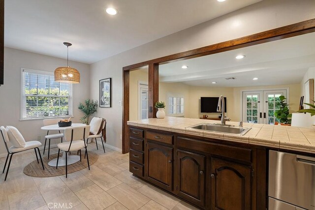 406 University Ave, Burbank, CA 91504 - kitchen with french doors, dark brown cabinets, recessed lighting, hanging light fixtures, and tile counters
