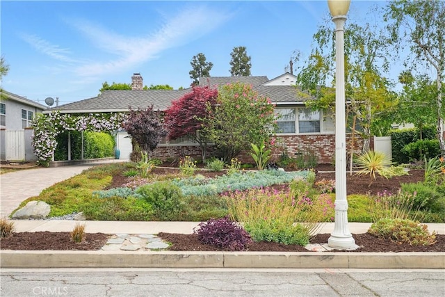 406 University Ave, Burbank, CA 91504 - obstructed view of property with brick siding, driveway, and a chimney