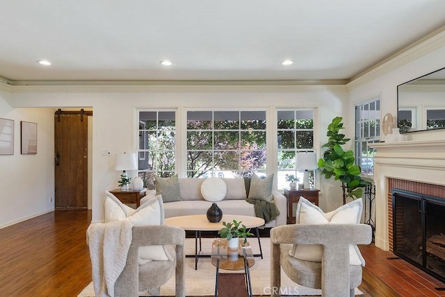 406 University Ave, Burbank, CA 91504 - living room featuring wood finished floors, a barn door, a fireplace, crown molding, and recessed lighting