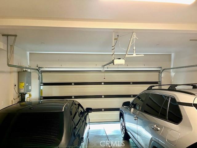 11 Lilac Ln, Compton, CA 90221 - garage featuring water heater and a garage door opener