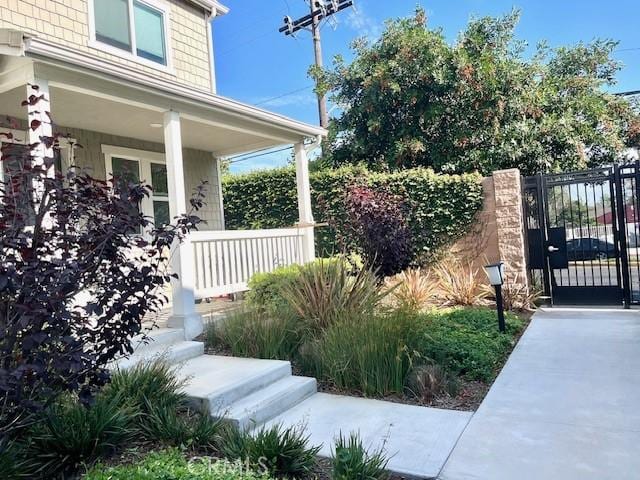 11 Lilac Ln, Compton, CA 90221 - view of property exterior with covered porch and a gate