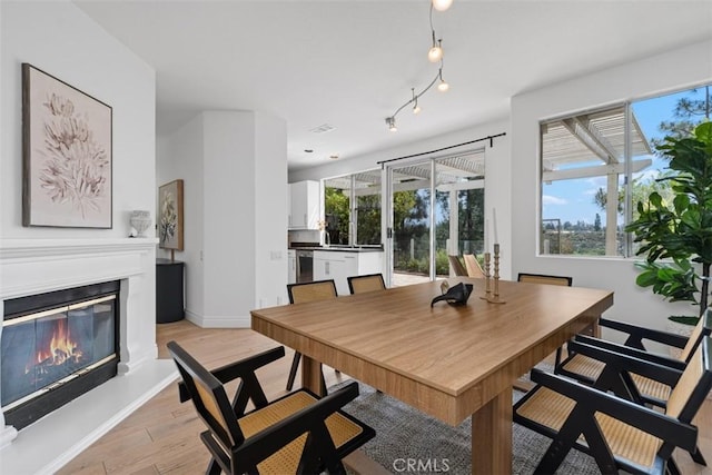 54 Hawaii Dr, Aliso Viejo, CA 92656 - dining space featuring light wood-style flooring and a glass covered fireplace
