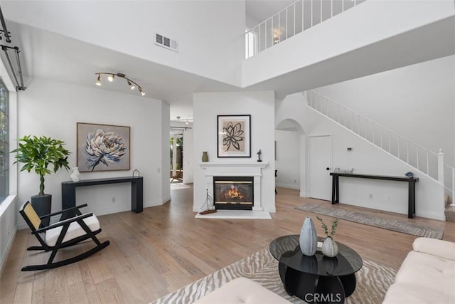 54 Hawaii Dr, Aliso Viejo, CA 92656 - living area featuring stairway, wood finished floors, and arched walkways