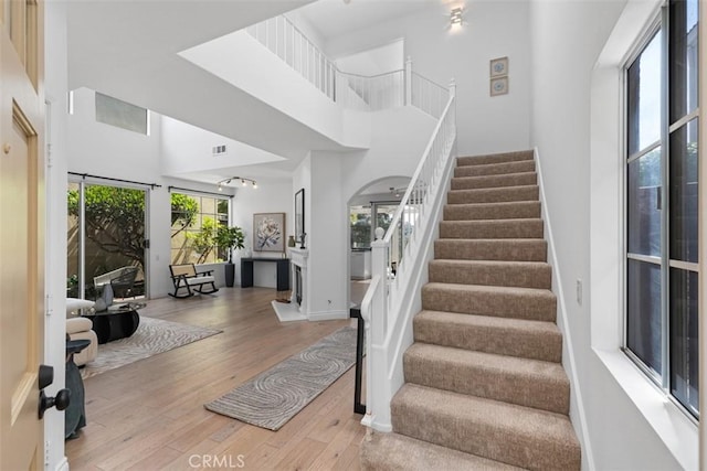 54 Hawaii Dr, Aliso Viejo, CA 92656 - stairs with a high ceiling and hardwood / wood-style flooring