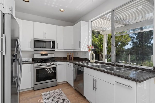 54 Hawaii Dr, Aliso Viejo, CA 92656 - kitchen featuring stainless steel appliances, recessed lighting, white cabinetry, and light wood-style floors