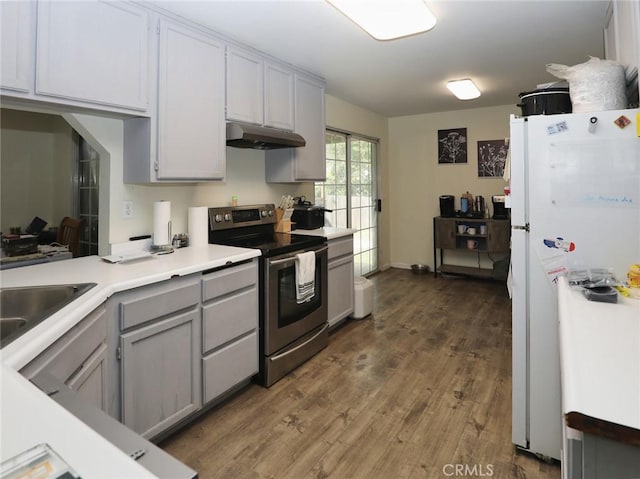 3687 Madison Dr, Clearlake, CA 95422 - kitchen featuring stainless steel range with electric cooktop, freestanding refrigerator, under cabinet range hood, gray cabinetry, and wood finished floors