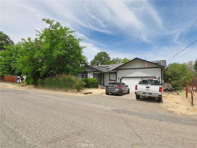 3687 Madison Dr, Clearlake, CA 95422 - view of front of home featuring solar panels, driveway, and a garage