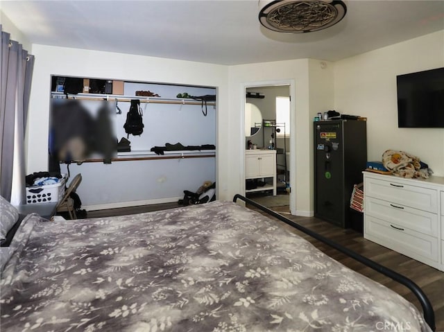 3687 Madison Dr, Clearlake, CA 95422 - bedroom featuring wood finished floors, freestanding refrigerator, and connected bathroom