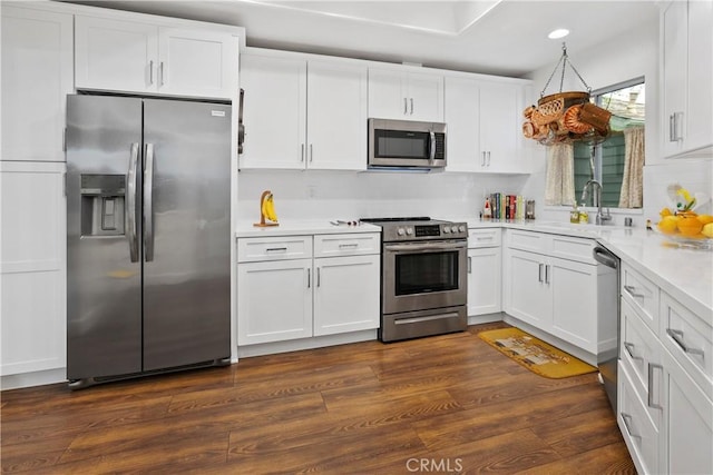 273 Haverfield Unit 156, Newport Beach, CA 92660 - kitchen featuring appliances with stainless steel finishes, white cabinets, light countertops, recessed lighting, and dark wood finished floors