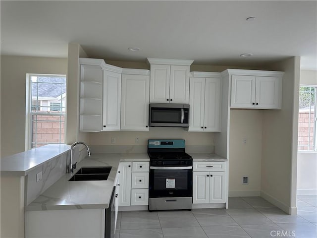 5215 Peony Ct, Riverside, CA 92506 - kitchen with stainless steel appliances, open shelves, white cabinets, and recessed lighting