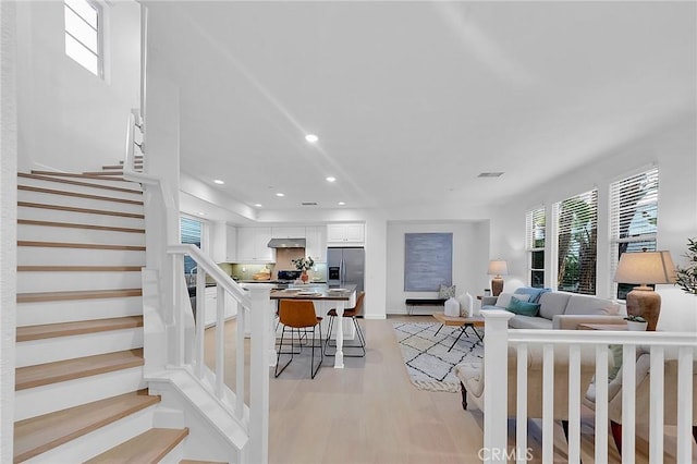 1749 Grand Ave Unit 4, Long Beach, CA 90804 - living area with light wood finished floors, stairs, plenty of natural light, and recessed lighting