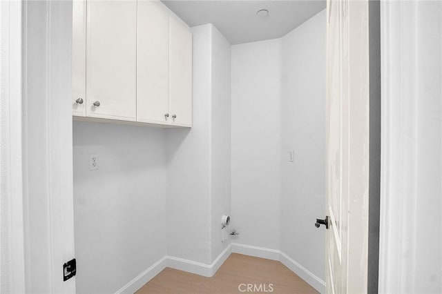 1749 Grand Ave Unit 4, Long Beach, CA 90804 - laundry area with light wood-style floors and cabinet space