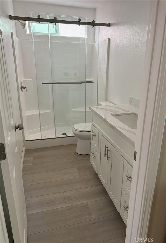 7398 N Maple Ave, Fontana, CA 92336 - full bath featuring a shower stall, vanity, and wood finished floors