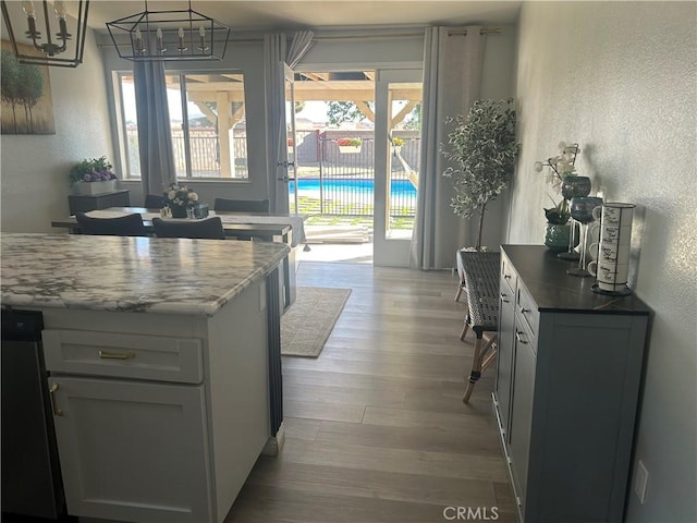 2258 El Rio St, Lancaster, CA 93535 - kitchen featuring a textured wall, wood finished floors, and a chandelier