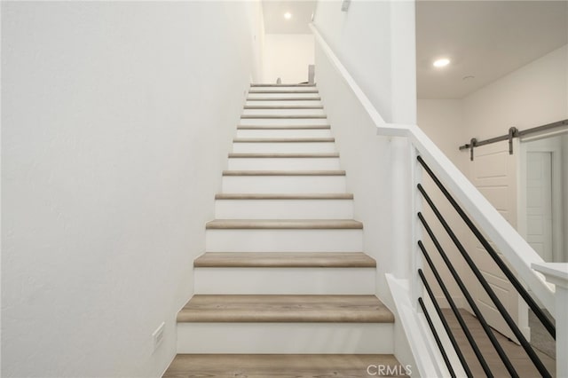 480 W Balsam Ln, Clovis, CA 93611 - stairs with wood finished floors, a barn door, and recessed lighting