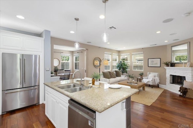 15809 Concord Rdg, San Diego, CA 92127 - kitchen with stainless steel appliances, open floor plan, dark wood-type flooring, white cabinets, and hanging light fixtures