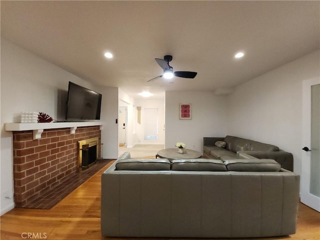 1150 W Santa Clara Ave, Santa Ana, CA 92706 - living area with light wood finished floors, a brick fireplace, ceiling fan, and recessed lighting