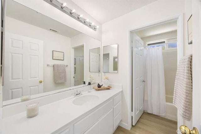 5444 Broderick Ct, Hemet, CA 92544 - bathroom with vanity, shower / bathtub combination with curtain, and wood finished floors