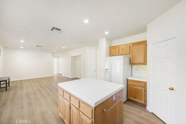 5444 Broderick Ct, Hemet, CA 92544 - kitchen featuring a kitchen island, tile countertops, light wood-style flooring, recessed lighting, and white refrigerator with ice dispenser