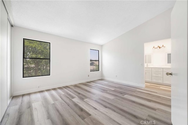 14225 Woodpark Dr, Moreno Valley, CA 92553 - spare room with plenty of natural light, lofted ceiling, and light wood-style floors