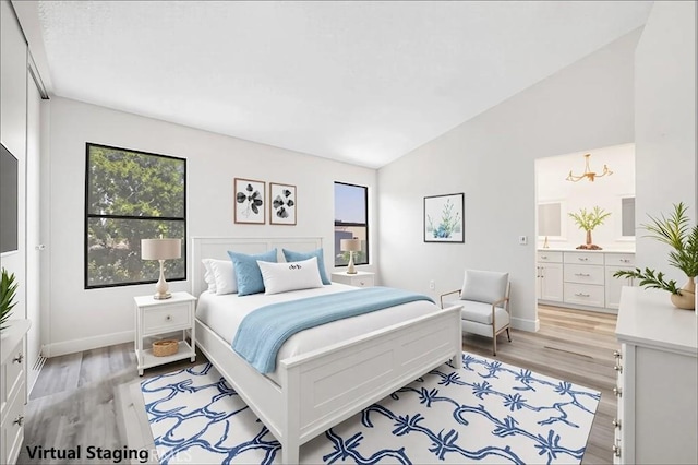 14225 Woodpark Dr, Moreno Valley, CA 92553 - bedroom with multiple windows, lofted ceiling, light wood-style flooring, and connected bathroom