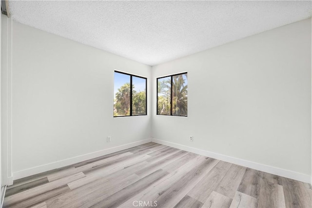 14225 Woodpark Dr, Moreno Valley, CA 92553 - spare room with light wood-type flooring and a textured ceiling