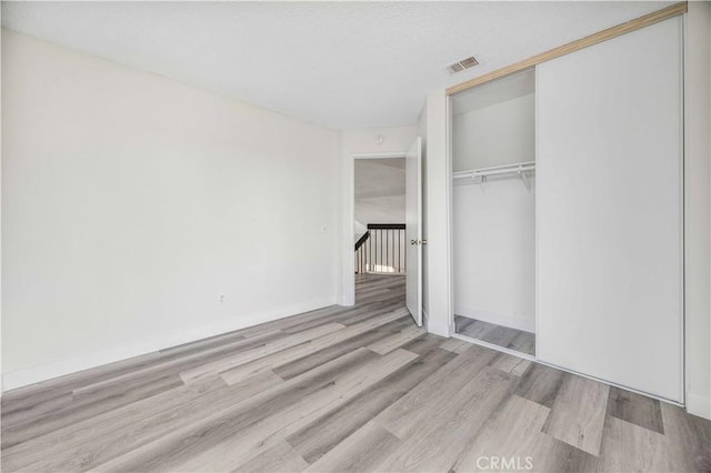 14225 Woodpark Dr, Moreno Valley, CA 92553 - unfurnished bedroom featuring wood finished floors and a closet